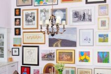 a colorful gallery wall with mismatching vintage frames, with and without mats, with art in various bright colors