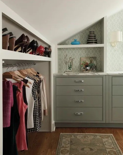 a cool and stylish attic closet with a built-in shoe shelf and railing for clothes right in the sloped part of the room