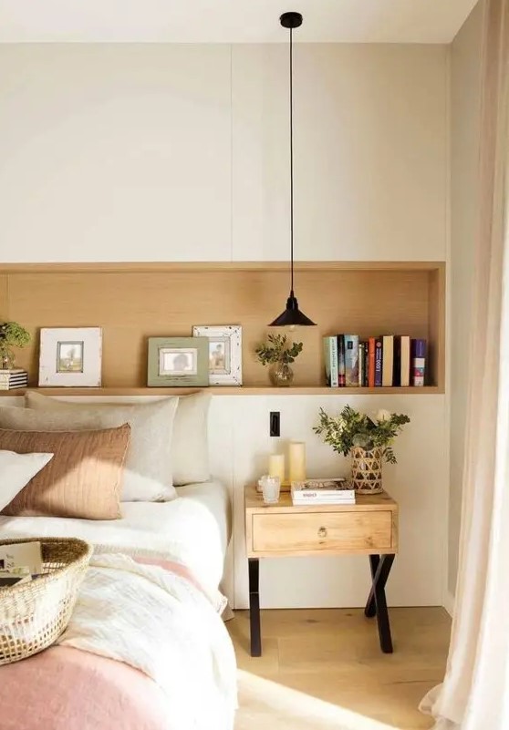 a cozy Spanish farmhouse bedroom with a niche used for decorating, a bed with neutral bedding and a wooden nightstand