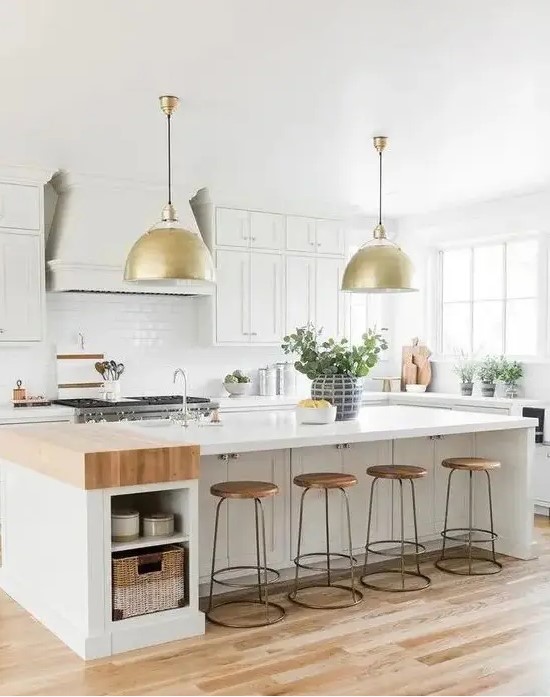 a creamy modern country kitchen with shaker style cabinets, a large kitchen island with storage, gold pendant lamps