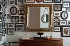 a fantastic vintage space with a rounded credenza, a printed rug and a rounded chair, a mirror and a free form black and white gallery wall that takes several walls