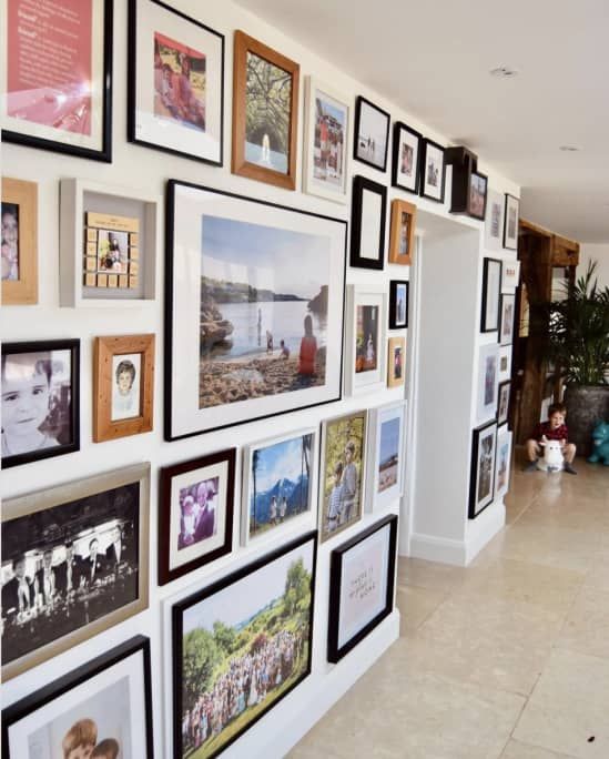 a floor to ceiling gallery wall with mismatching frames and eclectic works of art is a gorgeous and lovely idea for your home