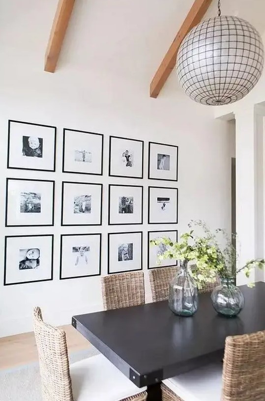 a grid gallery wall with matching black frames and clear space instead of matting and black and white photos