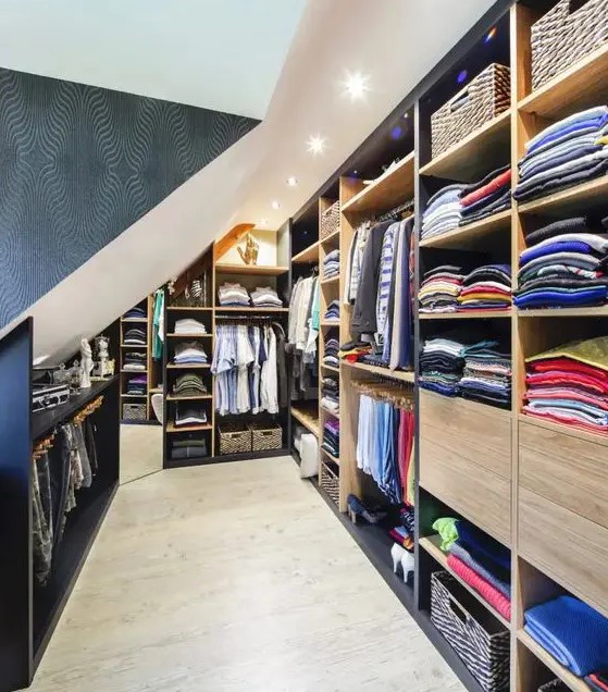 a large attic closet with open storage compartments and rails, built-in storage units is a very smart and cool idea