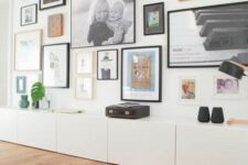 a large storage unit and a floor to ceiling eclectic gallery wall with mismatching frames are a cool combo for any space