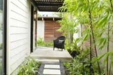 a low-maintenance side yard with pebbles, tiles, greenery and bamboo is a lovely idea for a modern home