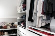 a minimalist white closet with open storage compartments, shoe shelves and drawers is a lovely neutral space