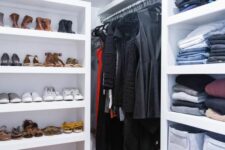 a modern attic closet done with shelves, railing with various stuff is a cool and smart solution with great organization