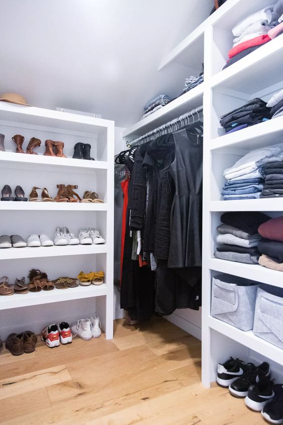 a modern attic closet done with shelves, railing with various stuff is a cool and smart solution with great organization