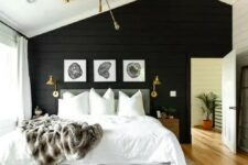 a lovely bedroom with a black accent wall
