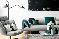 a modern living room with light grey upholstery and a couple of green accents