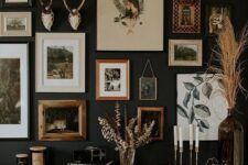 a moody gallery wall with mismatching frames but with the same theme, woodlands, and with antlers