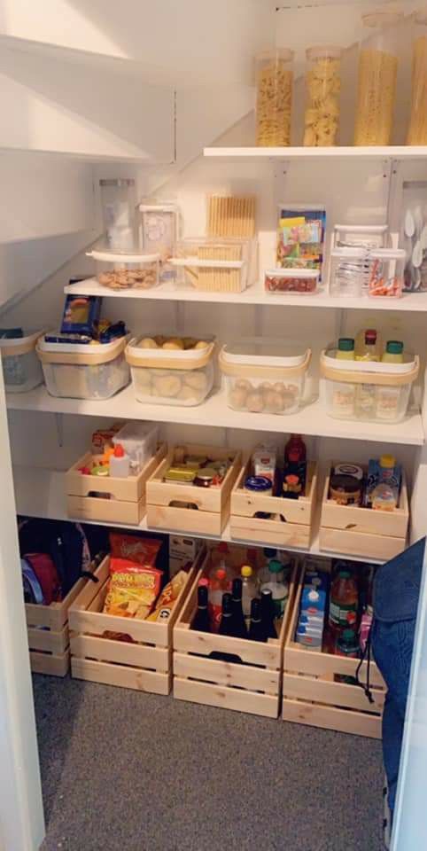 a pantry under the stairs with open shelves and cubbies, with lights and clear containers is a cool idea