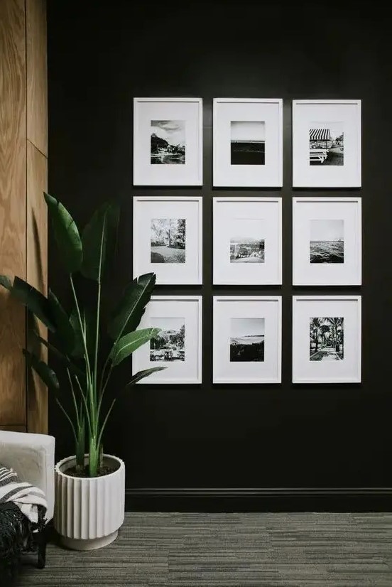 a simple symmetrical gallery wall with black and white prints in matching white frames is a cool and chic idea