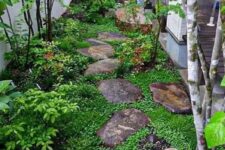 a small Japanese-inspired side yard with rocks as pavements, greenery, shrubs and a couple of trees is very peaceful