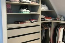 a small attic closet with open storage compartments, drawers and rails for clothes is a cool idea if you don’t have much space for a closet