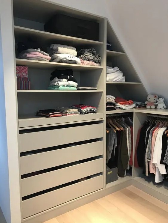 a small attic closet with open storage compartments, drawers and rails for clothes is a cool idea if you don't have much space for a closet