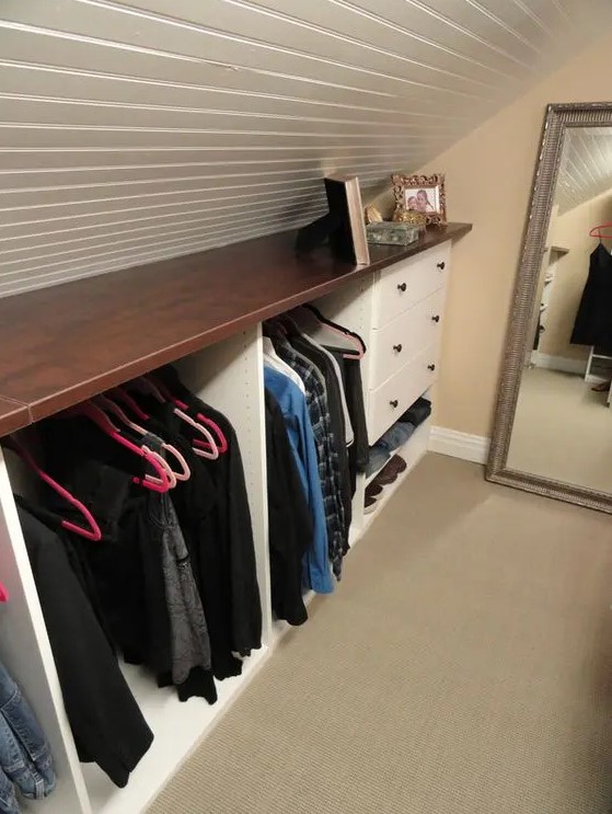 a small attic storage unit with a stained countertop, open departments and drawers is a very cool idea for any space