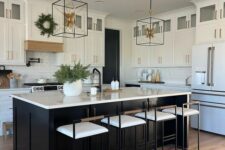 a stylish white kitchen with a black kitchen island, white stone countertops and a tile backsplash, tall stools and pendant lamps