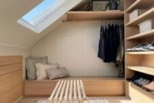 a tiny attic closet with open shoe shelves and a railing plus a storage daybed and a bench is a lovely space