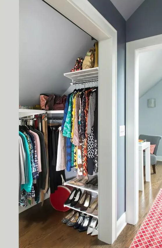 a tiny attic walk-in closet with railings and shelves, with shoe shelves is a cool idea if you don't have much space