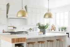 a white modern farmhouse kitchen with shaker cabinets, a large kitchen island with storage space, a white tile backsplash and pendant lamps