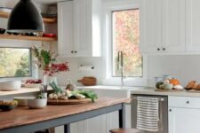 a white modern farmhouse kitchen with shaker cabinets, a soot table and kitchen island, pendant lamps and wooden stools