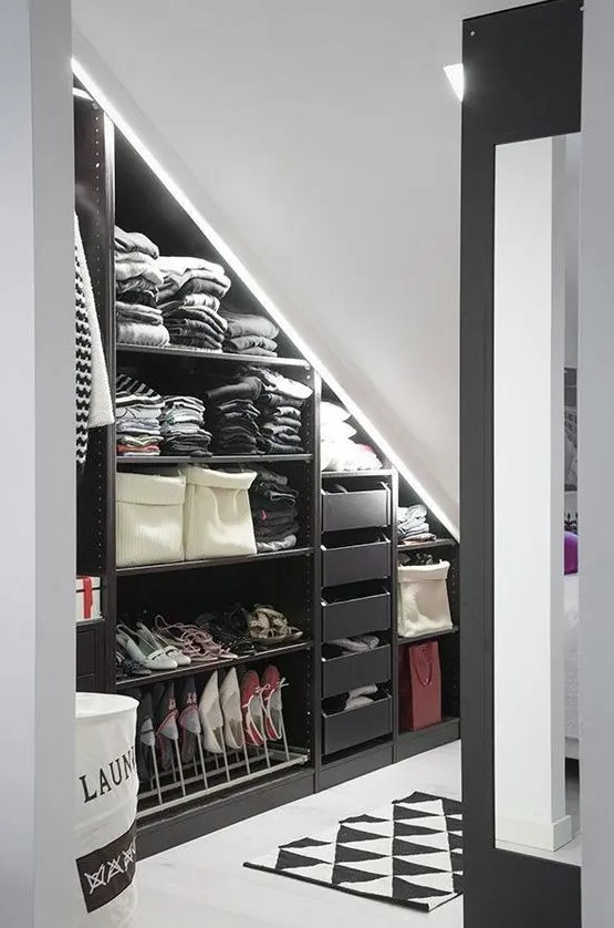 an attic nook as a closet, with open shelves, drawers and built-in lights, a printed rug is a cool and smart idea if you lack space