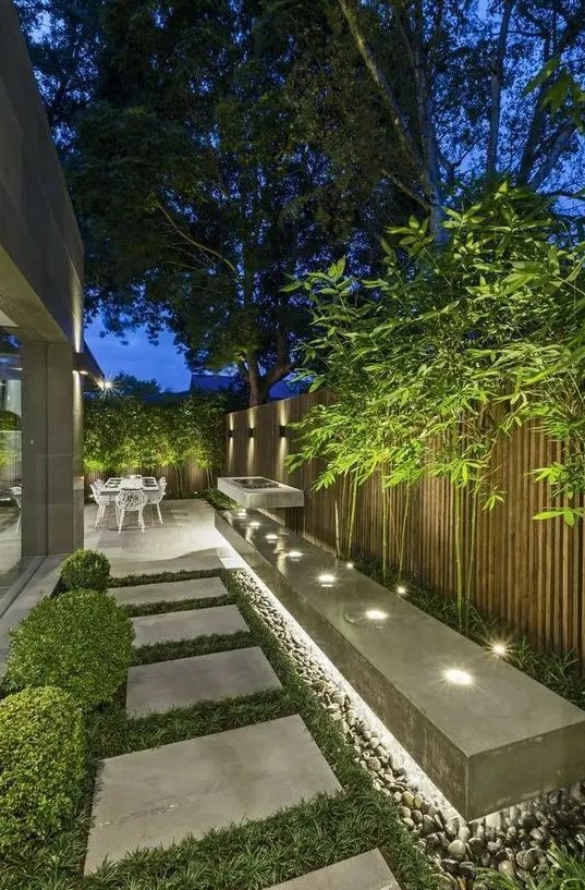 an outdoor space lit up with hidden lights, with built-in lights looks modern, fresh and bold and is very lit up
