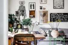 an oversized eclectic gallery wall done in free form, with lots of various types of art is amazing for a Scandi or eclectic space