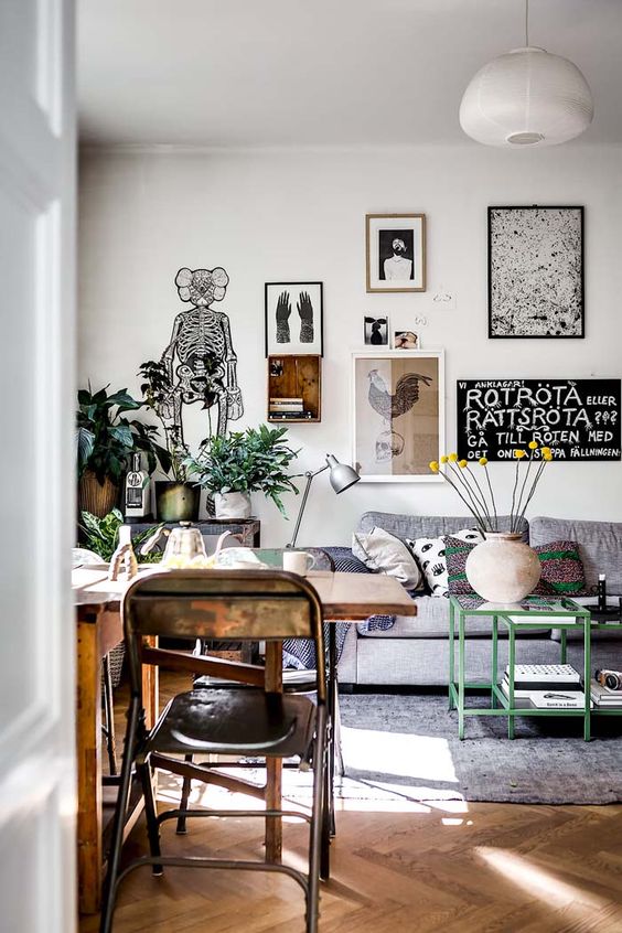 an oversized eclectic gallery wall done in free form, with lots of various types of art is amazing for a Scandi or eclectic space