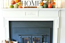 02 a bright and cool fall rustic mantel with lots of colorful pumpkins, fall leaf branches and candle lanterns plus a sign on top
