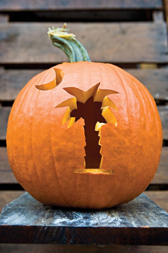 a Halloween jack-o-lantern with a palm tree and a moon is a simple and cool idea to make yourself