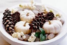 03 a beautiful fall or Thanksgiving centerpiece of pumpkins, pinecones, pebbles, berries and green leaves is easy to repeat