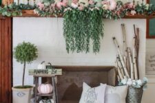 04 a bright fall mantel with cascading greenery, pastel pumpkins, greenery, branches in a bucket and a wooden basket