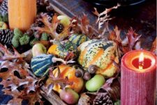 05 a colorful harvest centerpiece of pinecones, apples, leaves, moss, gourds and colorful candles