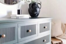 06 a blue fluted IKEA dresser hack with copper knobs and lovely decor on it is a stylish and chic idea for a modern space