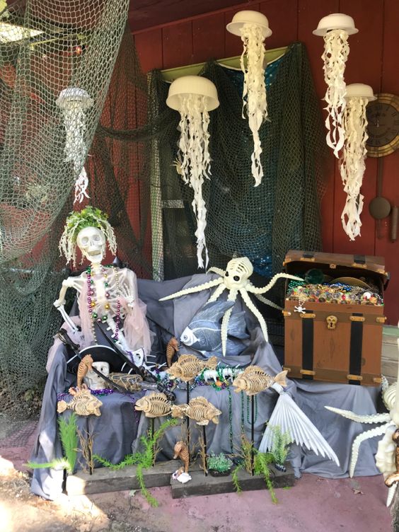 a beach Halloween skeleton scene with a tropical skeleton, some jellyfish, an octopus and some greenery