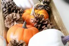 08 a fall centerpiece of a wooden bowl, pinecones, pumpkins and wooden beads is a cool idea for fall decor