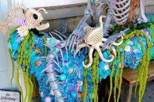 09 a Halloween mermaid with long hair, a skeleton fish and an octopus, a blue blanket and greenery