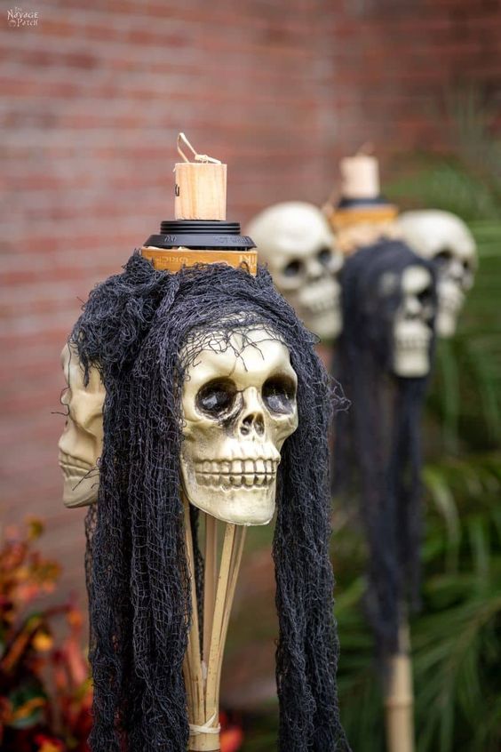 a simple Halloween decoration of skulls, with black cheesecloth and a candle on top is bold and cool