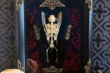 11 a refined Halloween art piece – a bat skeleton in a coffin and in a refined frame is great for Halloween decor