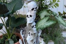 11 a skull stack with hay and skeleton hands is a cool decoration for Halloween