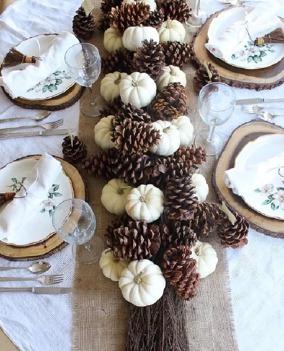 a fall table runner of mini pumpkins and large pinecones is a cool rustic decoration to make