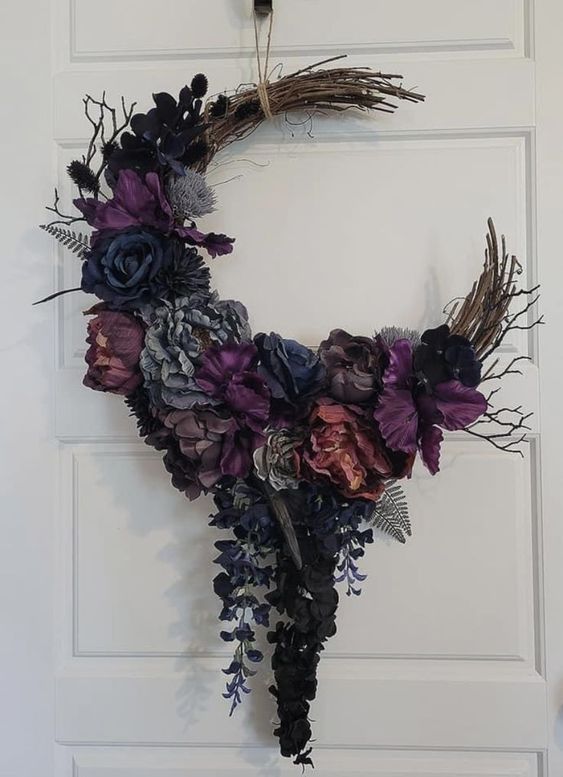 an adorable moody Halloween wreath as a half moon, with purple, grey and burgundy paper blooms