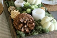13 a gorgeous fall centerpiece of a crate with moss, succulents, candles, usual and bleached pinecones and pumpkins