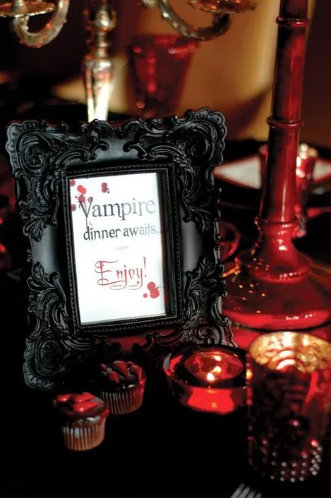 a stylish black framed sign, dark red and black decorations around