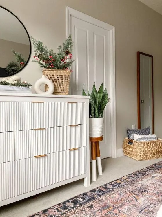 a fluted IKEA Hemnes hack with gold handles, with some vases, potted plants and decor is a perfect match for a modern space