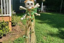 14 a tropical Halloween decoration of a skull, bones, greenery and some hay is a cool outdoor solution