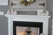 16 a fall fireplace styled with faux fur, fabric pumpkins and lights, a basket with firewood, candles and vases is a beautiful idea